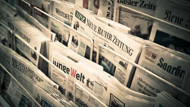German newspapers in a rack showing only the headlines - How to write a press release headline